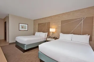 a hotel room with two beds and two lamps at Holiday Inn Express & Suites New Cumberland by IHG in New Cumberland