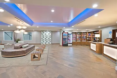 a large lobby with a couch and chairs in a room at Holiday Inn Express & Suites New Cumberland by IHG in New Cumberland
