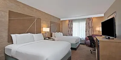 a hotel room with two beds and a flat screen tv at Holiday Inn Express & Suites New Cumberland by IHG in New Cumberland