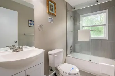 a bathroom with a sink and a toilet and a shower at Lounging in Long Pond in Long Pond