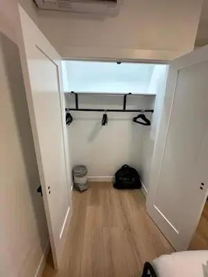 a small room with a hallway with a door and a shelf at The View - Direct Bus Time Square NYC Breakfast Included - D in Jersey City