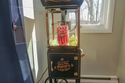 an old fashioned popcorn machine with a coca cola bottle at Cozy Lakefront Poconos Cabin Hot Tub Kayaks in Tobyhanna