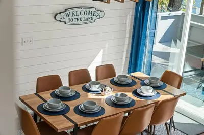 a wooden table with chairs and hats on it at Cozy Lakefront Poconos Cabin Hot Tub Kayaks in Tobyhanna