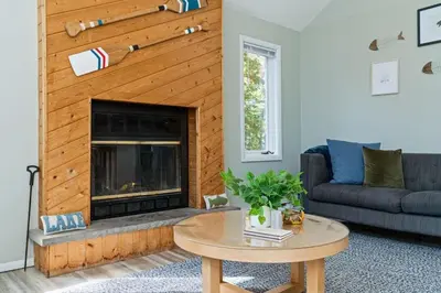 a living room with a couch and a fireplace at Cozy Lakefront Poconos Cabin Hot Tub Kayaks in Tobyhanna