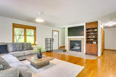 a living room with a couch and a fireplace at Home Theater and Game Room Home in Glen Wild! in Glen Wild