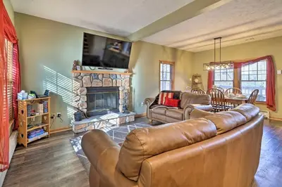 a living room with a couch and a fireplace at HOT TUB 4 Min Dr to Camelbeach in Tannersville