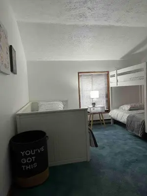 a bedroom with a bed and a trash can at Lovely tranquil spot for family and friends to gather in Tobyhanna