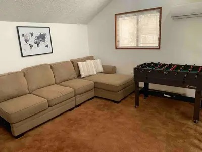 a living room with a couch and a table with a foos ball at Lovely tranquil spot for family and friends to gather in Tobyhanna