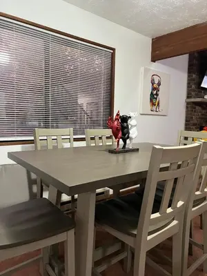 a dining room table with a cow statue on it at Lovely tranquil spot for family and friends to gather in Tobyhanna