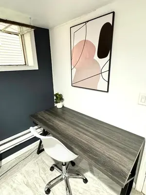 a room with a wooden table and a white chair at Open Serene Suite - 10mins-EWR, 25mins-NYC in Irvington