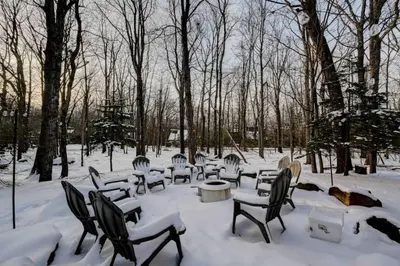 a group of chairs and tables in the snow at Cozy mountain house with beach access and firepit in Lake Harmony