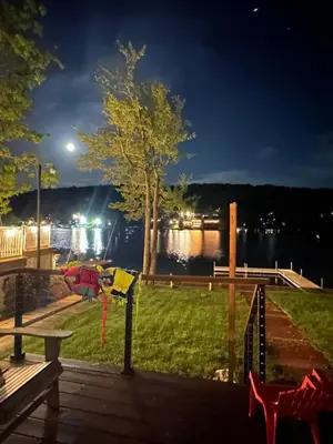 a view from the deck of a park at night at Lakefront home with kayaks fire pit hot tub and walk to restaurants and bars in Lake Harmony