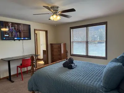 a bedroom with a teddy bear sitting on a bed at Lakefront home with kayaks fire pit hot tub and walk to restaurants and bars in Lake Harmony