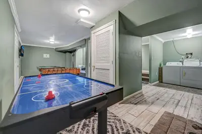 a room with a ping pong table in a room at Pocono Chalet Towamensing with Hot Tub Lake and Pool in Albrightsville
