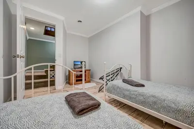 a bedroom with two beds and a mirror at Pocono Chalet Towamensing with Hot Tub Lake and Pool in Albrightsville