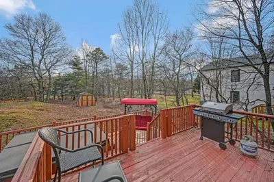 a wooden deck with a grill and a grill at Pocono Chalet Towamensing with Hot Tub Lake and Pool in Albrightsville