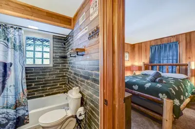 a bedroom with a bed and a tub and a shower at Lake harmony estates beach and lake access in Lake Harmony
