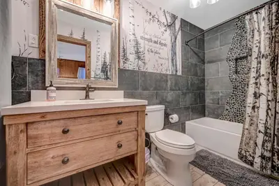 a bathroom with a sink and a toilet and a tub at Lake harmony estates beach and lake access in Lake Harmony