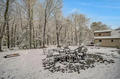 a group of chairs in the snow in front of a house at Lake harmony estates beach and lake access in Lake Harmony