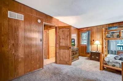 a bedroom with wooden walls and a bunk bed at Lake harmony estates beach and lake access in Lake Harmony