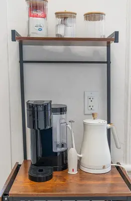 a shelf with a coffee maker and a blender on it at Modern Studio - Parking Available - 15 min NYC in Jersey City