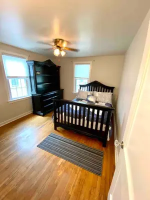 a bedroom with a crib and a ceiling fan at Family Home in mainheim PA close to atractions in Manheim
