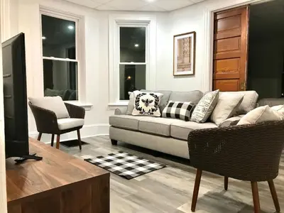 a living room with a couch and a chair at Cozy Lancaster Apartment Near Attractions in Lancaster