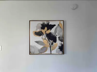 a framed painting of flowers on a wall at Cozy Lancaster Apartment Near Attractions in Lancaster