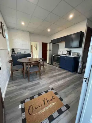 a kitchen with a table and a dining room at Cozy Lancaster Apartment Near Attractions in Lancaster