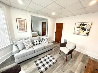 a living room with a couch and a chair at Cozy Lancaster Apartment Near Attractions in Lancaster