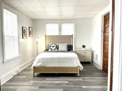 a bedroom with a bed in a white room at Cozy Lancaster Apartment Near Attractions in Lancaster