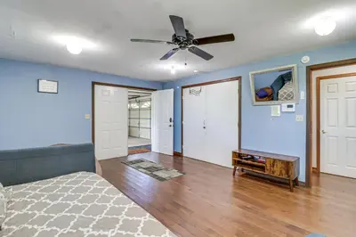 a bedroom with blue walls and a ceiling fan at Game Room! Lake-View Gem 7 Mi to Camelback Slopes in Long Pond