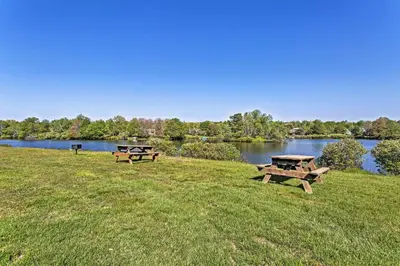 two picnic tables in a field next to a lake at Game Room! Lake-View Gem 7 Mi to Camelback Slopes in Long Pond