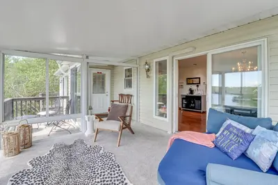 a living room with a blue couch and a balcony at Game Room! Lake-View Gem 7 Mi to Camelback Slopes in Long Pond