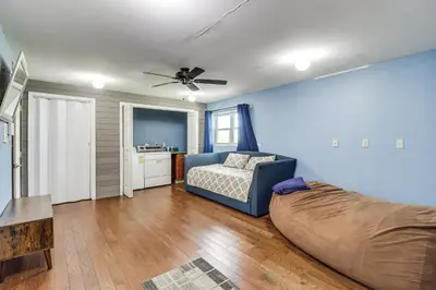 a living room with a couch and a bed at Game Room! Lake-View Gem 7 Mi to Camelback Slopes in Long Pond