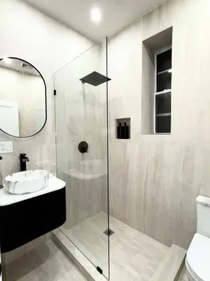 a bathroom with a shower with a sink and a toilet at The View - Direct Bus Time Square NYC Breakfast Included - A in Jersey City
