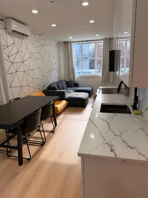 a kitchen and living room with a table and a couch at The View - Direct Bus Time Square NYC Breakfast Included - B in Jersey City