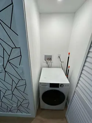 a laundry room with a washing machine in a room at The View - Direct Bus Time Square NYC Breakfast Included - B in Jersey City