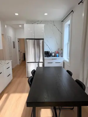 a kitchen with a black table and a refrigerator at The View - Direct Bus Time Square NYC Breakfast Included - B in Jersey City