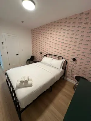 a bedroom with a bed with two towels on it at The View - Direct Bus Time Square NYC Breakfast Included - C in Jersey City