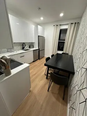 a kitchen with a black table and chairs in a room at The View - Direct Bus Time Square NYC Breakfast Included - C in Jersey City