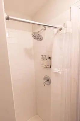 a shower with a shower curtain in a bathroom at Bayonne Bay Inn in Bayonne