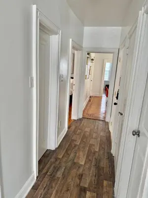 an empty hallway with white walls and wood floors at Heaven on earth in Bayonne