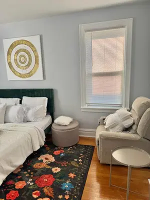 a bedroom with a bed and a couch and a rug at Heaven on earth in Bayonne