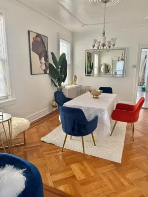 a dining room with a white table and blue chairs at Heaven on earth in Bayonne