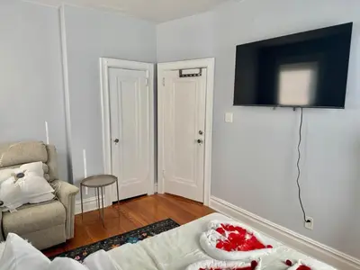 a living room with a couch and a tv on the wall at Heaven on earth in Bayonne