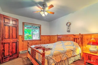 a bedroom with a bed and a ceiling fan at Charming Forest Cabin with a Hammock near Delaware Water Gap National Recreation Area, Pennsylvania in Canadensis