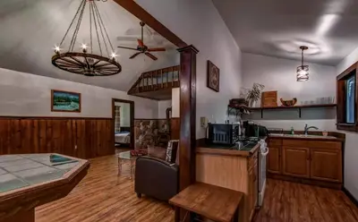 a kitchen and living room with a ceiling fan at Cozy Cottage Rental with Small Private Pond in Canadensis, Pennsylvania in Canadensis