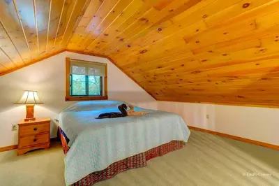 a bedroom with a bed and a wooden ceiling at Traditional Wooden Cabin Rental in the Poconos, Pennsylvania in Canadensis