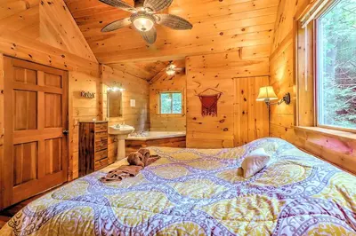 a bedroom with a bed in a wooden cabin at Idyllic Log Cabin Rental with a Porch in the Poconos of Pennsylvania in Canadensis